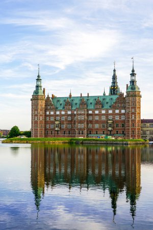 Frederiksborg castle in Hillerod, Denmark, lakeside facade, beautiful renaissance palace facade reflection in lake water