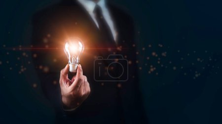 Businessman holding Bright light bulb. Ideas,innovative,technology and creativity concept.