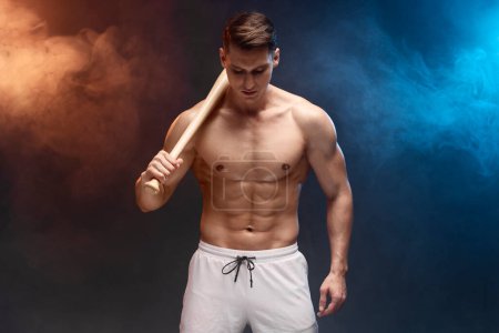 Photo for Waist up portrait view of muscle man posing in studio with baseball bat. Sporty muscular guy athlete. Sport and fitness concept - Royalty Free Image