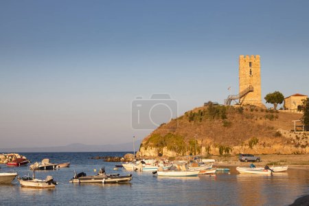 Photo for The Byzantine tower of Nea Fokea port in Kassandra peninsula, in Halkidiki region of Greece, at dusk - Royalty Free Image