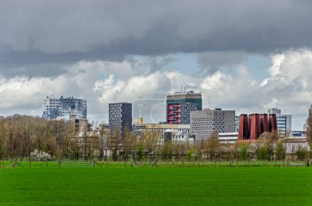 Photo for Utrecht, The Netherlands, March 24, 2023: the Uithof university campus seen across green fields under a cloudy sky - Royalty Free Image