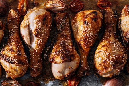 Photo for Baked chicken drumsticks with sesame, honey and soy sauce, onion and spices - Royalty Free Image