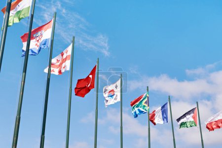 India, France, Croatia, Turkey, Georgia, South Korea, France, South Africa, Palestine flags on blue sky
