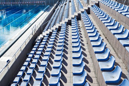 Spectator plastic seats at outdoor swimming pool