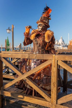 Foto de Colorful carnival mask against gondolas at a traditional festival in Venice, Italy - Imagen libre de derechos