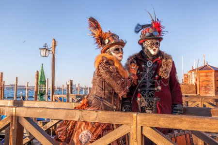 Foto de Colorful carnival masks against gondolas at a traditional festival in Venice, Italy - Imagen libre de derechos