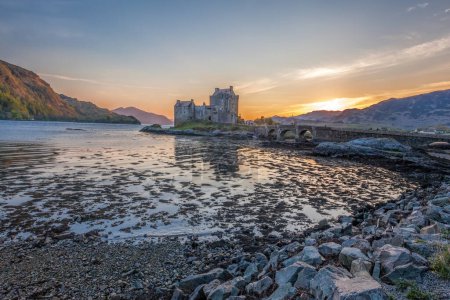 Photo for Colorful sunset against Eilean Donan Castle at Kyle of Lochalsh in the Western Highlands of Scotland - Royalty Free Image