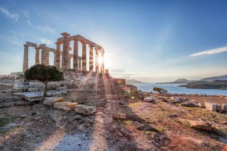 Cape Sounion with ruins of an ancient Greek temple of Poseidon during of sunset over sea in Greece
