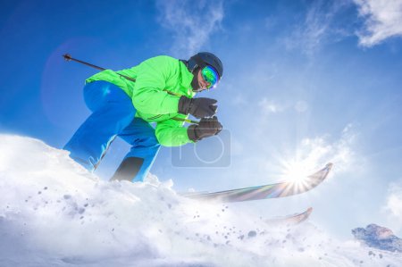 Photo for Skier skiing downhill in high mountains against against the fairytale winter forest. - Royalty Free Image