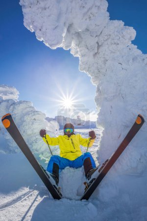 Téléchargez les photos : Skier is having fun during beautiful winter scenery in high mountains against sunset. - en image libre de droit