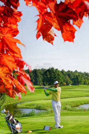 Photo for Man playing golf during colorful autumn - Royalty Free Image