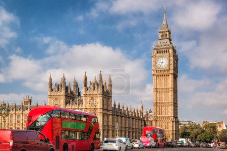 Photo for Big Ben with typical red buses on the bridge in London, England, UK - Royalty Free Image