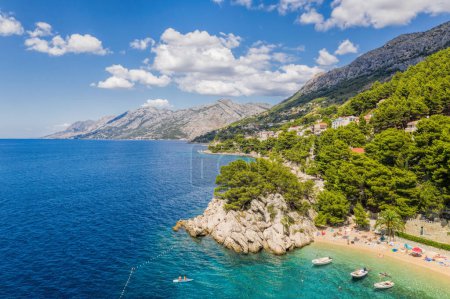 Foto de Vista aérea de la playa de Punta Rata con barcos y mar azul en Brela, Croacia, Dalmacia, costa azul croata - Imagen libre de derechos