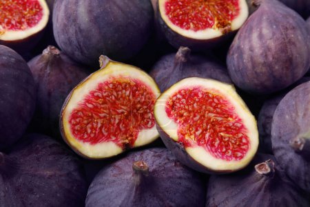 Photo for Cut and whole fresh ripe figs as background, top view - Royalty Free Image