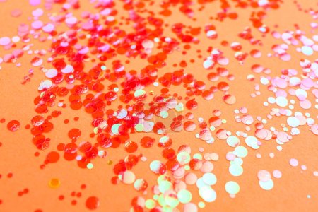 Photo for Shiny bright red glitter on pale coral background - Royalty Free Image