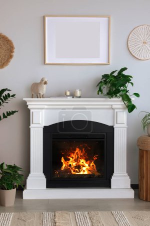 Photo for Beautiful living room interior with fireplace and green houseplants - Royalty Free Image