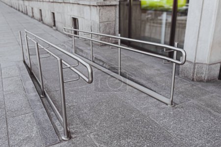 Photo for Tiled ramp with shiny metal railings outdoors - Royalty Free Image