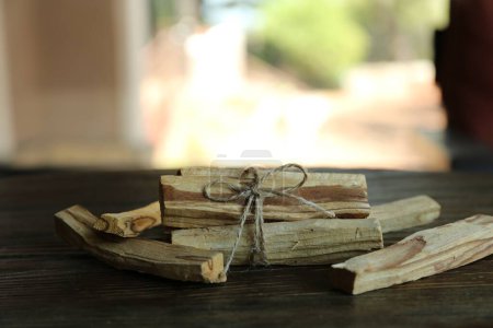 Photo for Palo santo sticks on wooden table, closeup - Royalty Free Image