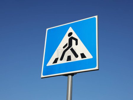 Téléchargez les photos : Traffic sign Pedestrian Crossing against blue sky, low angle view - en image libre de droit