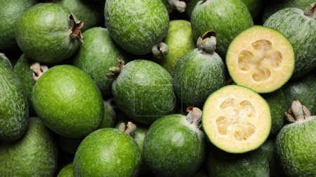 Fresh green feijoa fruits as background, closeup. Banner design