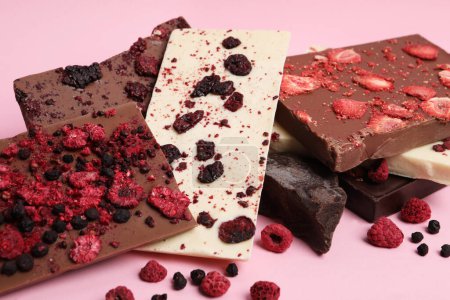 Photo for Different chocolate bars with freeze dried fruits on pink background - Royalty Free Image