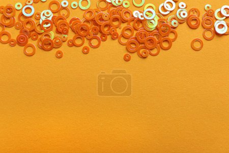 Photo for Shiny bright glitter on light orange background, flat lay. Space for text - Royalty Free Image