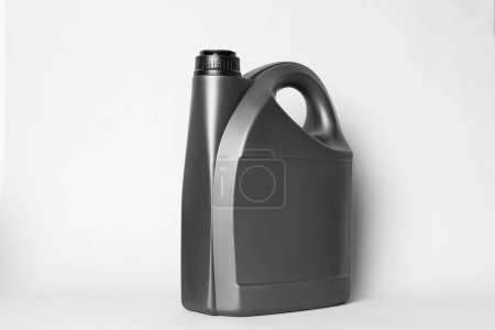 Motor oil in grey canister on light background
