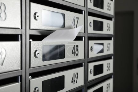 Photo for New mailboxes with keyholes, numbers and receipts, closeup - Royalty Free Image