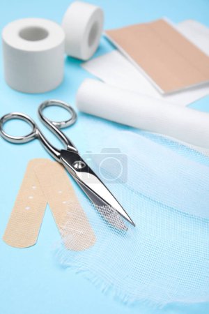 Photo for White bandage and medical supplies on light blue background, closeup - Royalty Free Image