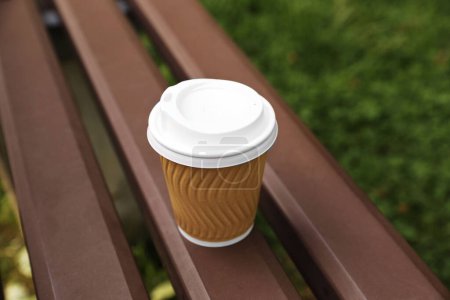 Photo for Paper cup on wooden bench outdoors. Coffee to go - Royalty Free Image