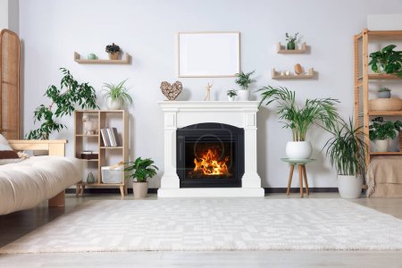 Photo for Stylish living room interior with fireplace, houseplants and beige sofa - Royalty Free Image