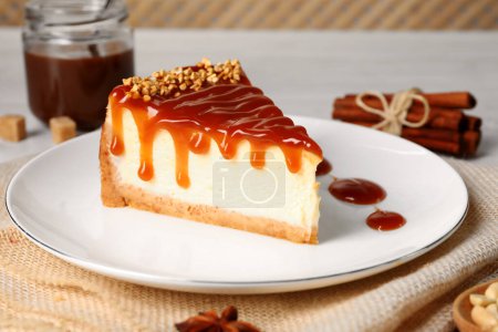 Photo for Tasty cheesecake with caramel and nuts served on table - Royalty Free Image