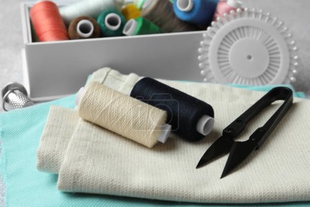 Photo for Spools of threads and sewing tools on table - Royalty Free Image