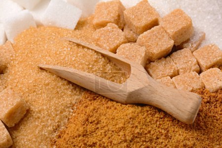 Photo for Scoop and different types of sugar as background, closeup - Royalty Free Image