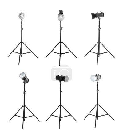 Photo for Set with studio flash lights on tripods against n white background - Royalty Free Image