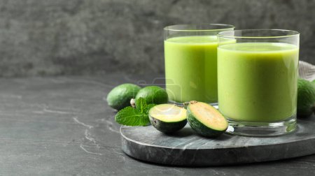 Photo for Fresh feijoa smoothie and fresh fruits on grey table, space for text. Banner design - Royalty Free Image