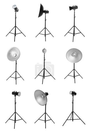 Photo for Set with studio flash lights with reflectors on tripods against white background - Royalty Free Image
