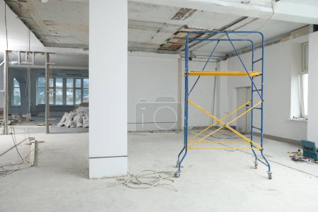 Photo for Scaffolds in messy room prepared for renovation - Royalty Free Image