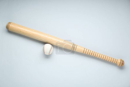 Photo for Wooden baseball bat and ball on light grey background, flat lay. Sports equipment - Royalty Free Image