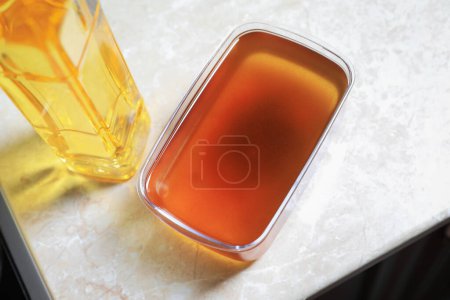 Photo for New and used cooking oil on beige marble table, above view - Royalty Free Image