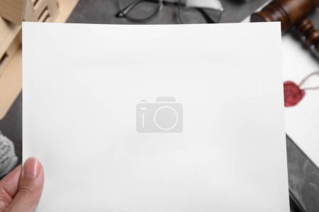 Photo for Woman holding last will and testament at grey table, closeup - Royalty Free Image