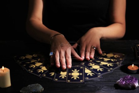 Foto de Soothsayer prediciendo el futuro con cartas del tarot en la mesa en la oscuridad, primer plano - Imagen libre de derechos