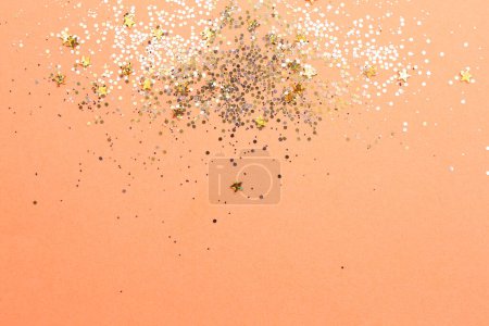 Photo for Shiny bright golden glitter on pale coral background, flat lay. Space for text - Royalty Free Image