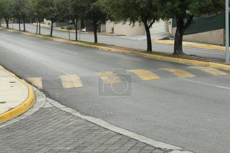 Photo for City street with striped concrete speed bump - Royalty Free Image