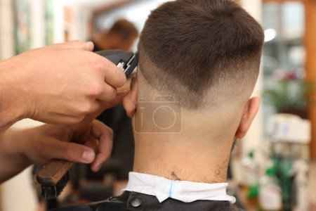 Téléchargez les photos : Coiffeur professionnel travaillant avec le client dans le salon de coiffure, gros plan - en image libre de droit