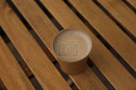 Photo for Takeaway paper cup with coffee on wooden table - Royalty Free Image
