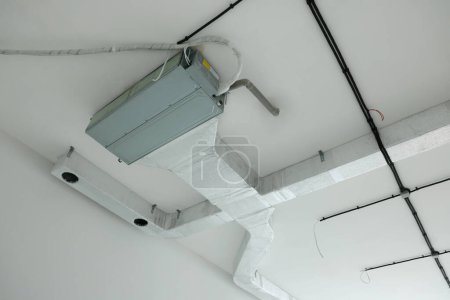 Photo for Ventilation system with pipes and wires on ceiling - Royalty Free Image