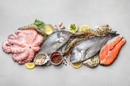 Photo for Flat lay composition with fresh raw dorado fish and different seafood on light grey table - Royalty Free Image