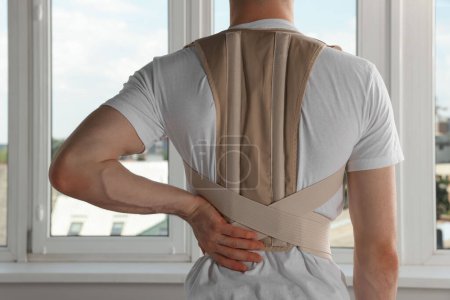 Photo for Closeup of man with orthopedic corset indoors, back view - Royalty Free Image