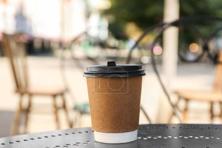 Photo for Paper cup on table in outdoor cafe. Takeaway drink - Royalty Free Image